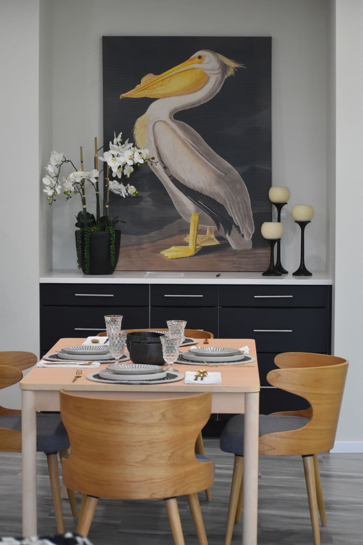 A dining area with coastal artwork